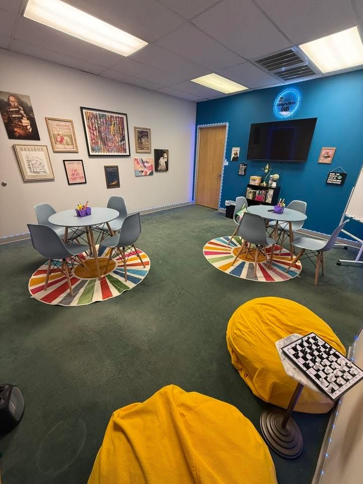 Bright, colorful tutoring room with sunburst rugs and bean bags